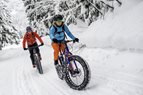 person riding bike in the snow