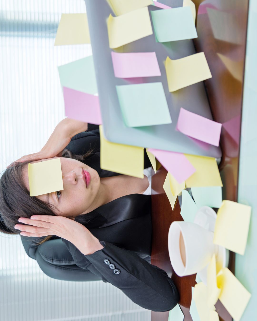 Employee stressed with lots of post it notes around.