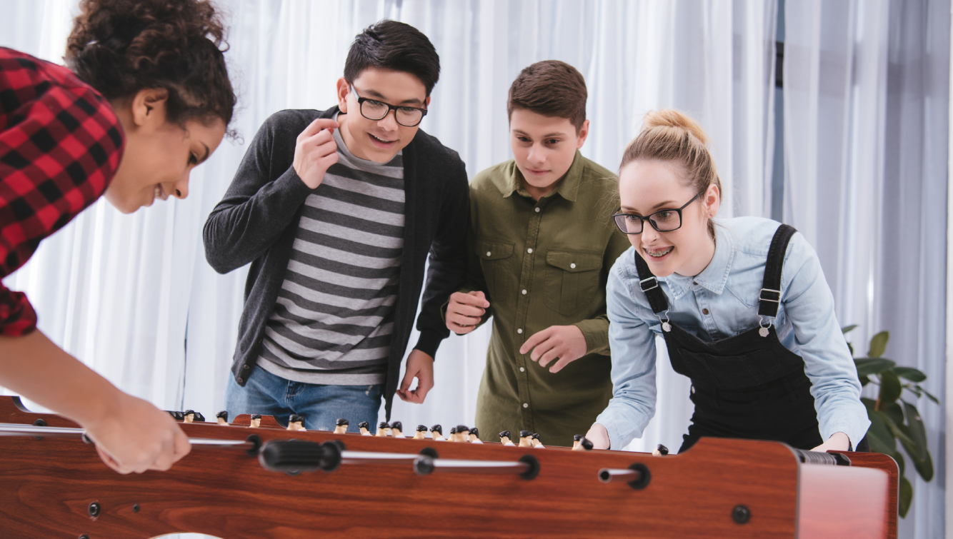 Youth playing fooseball