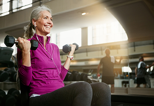 smiley woman lifting weights