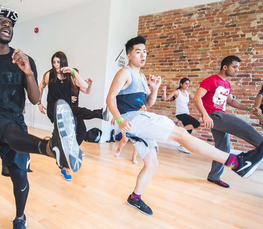 Men and women learn modern dance