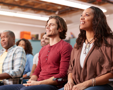A group of people sitting and listening to a speaker.