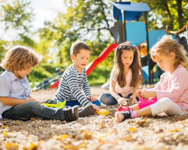 Children playing at a sunny playground.