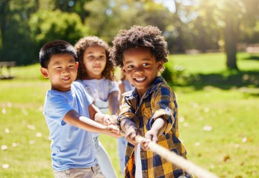 young kids playing and pulling rope