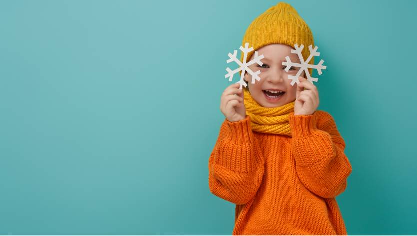 young child with snowflakes