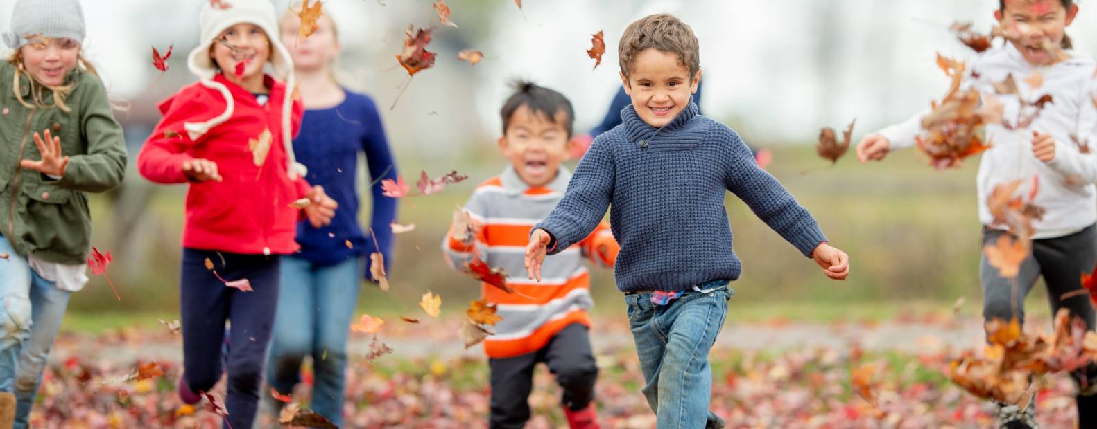 kids running in leaves