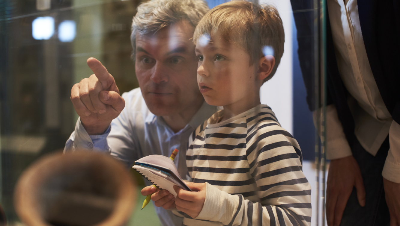 father and son in a museum