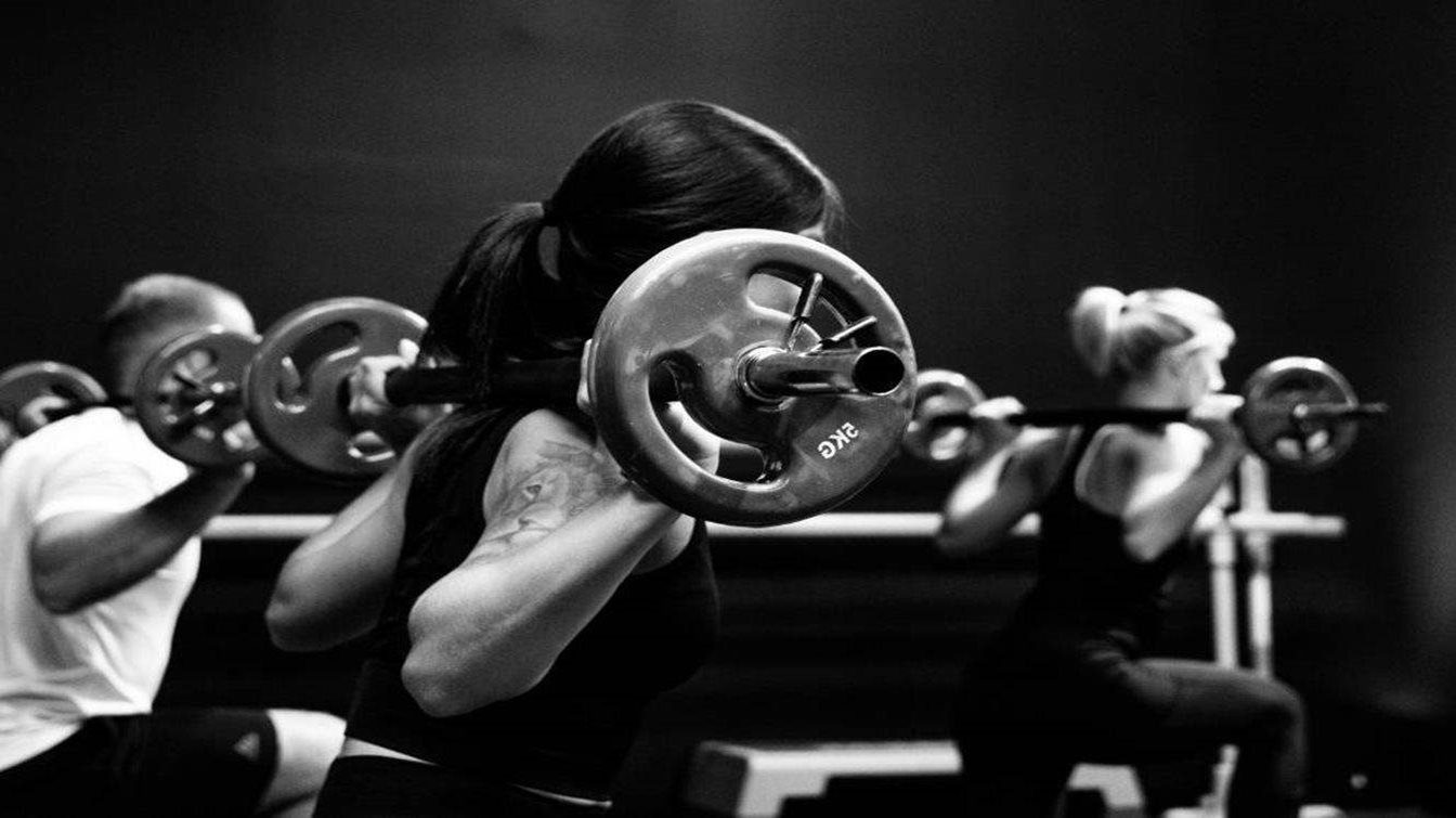 Men and women lifting weights
