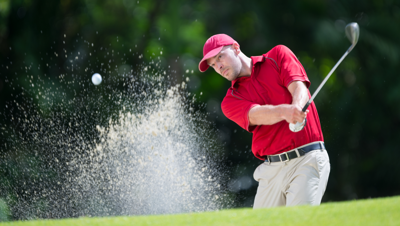 person hitting golf ball