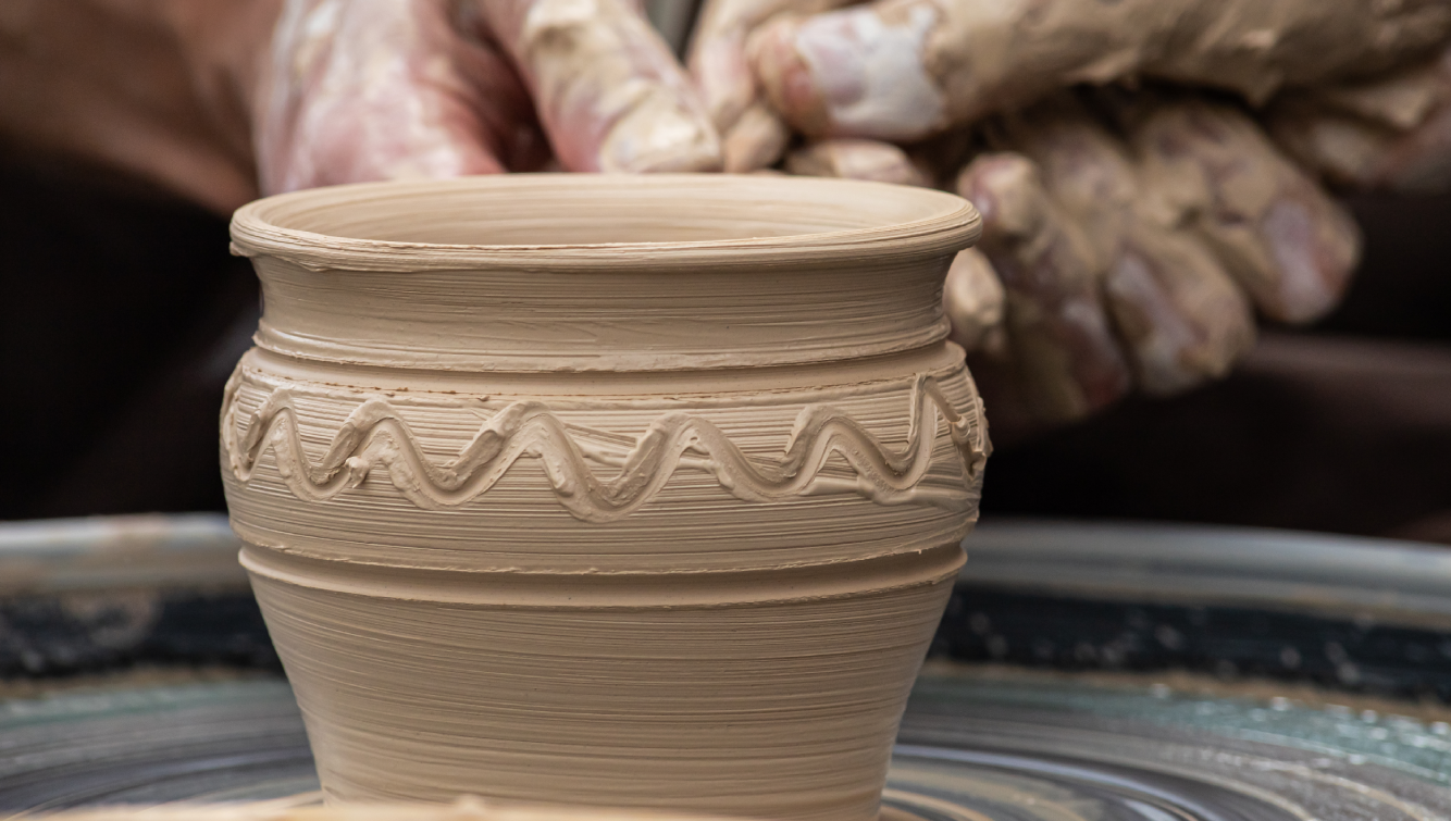 person working on a pot