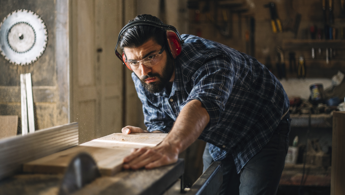 person cutting wood