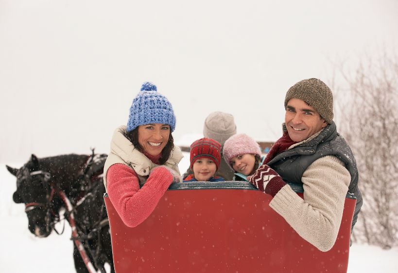 Family riding in horse drawn sleigh