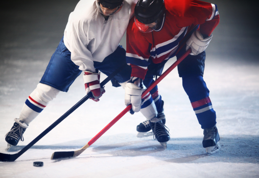 Two hockey players playing on the ice.