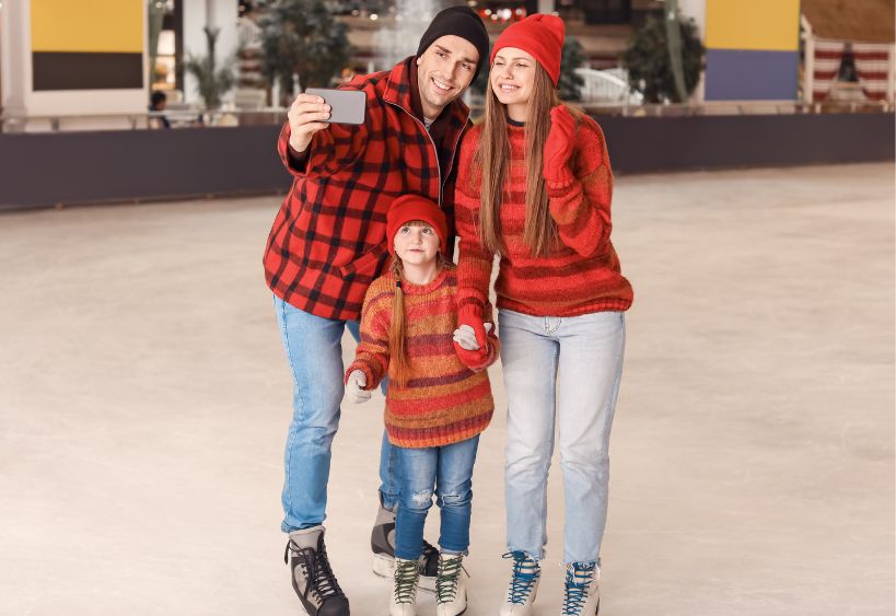 Family taking a selfie while skating on an ice rink
