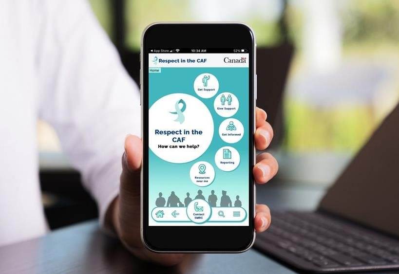 Person's hand holding mobile device with the RitCAF mobile App homepage