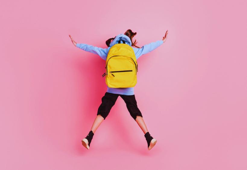 Back view of girl with backpack on jumping