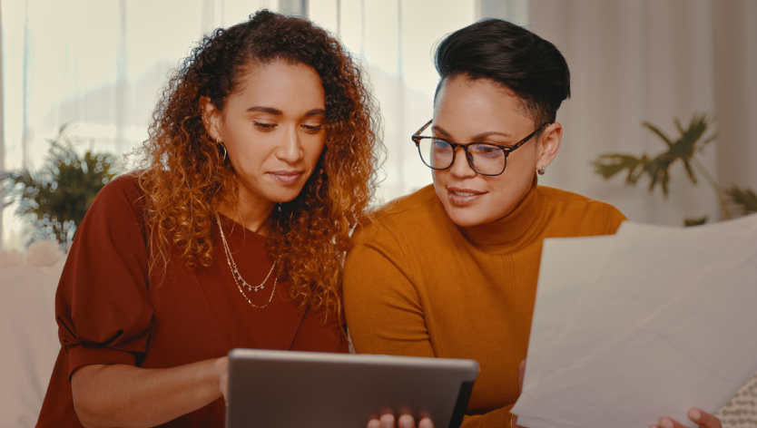 two people looking at a tablet