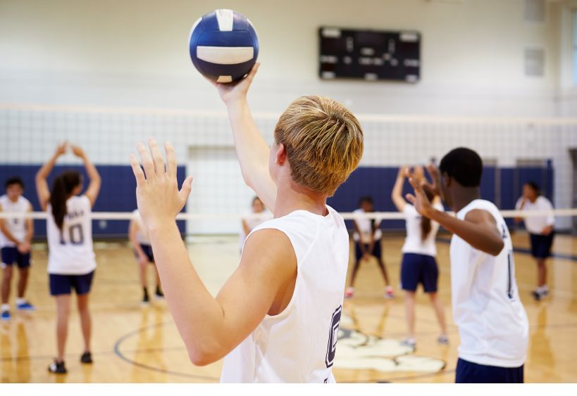 Teenagers playing Volleyball