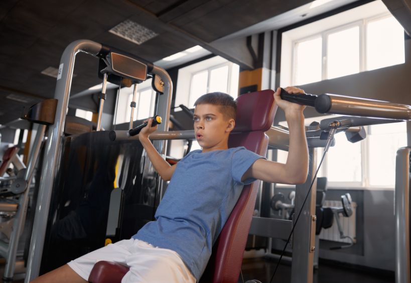 Teenager lifting weights
