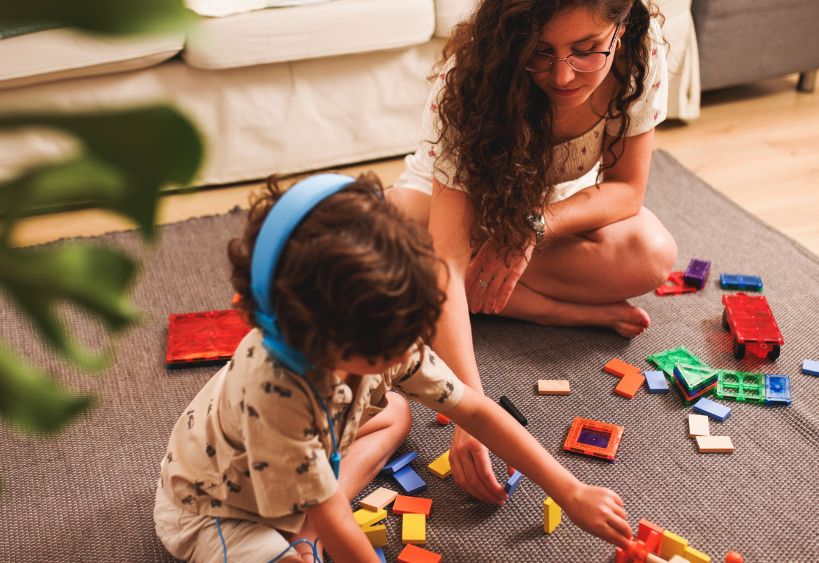 Teenager playing with a child