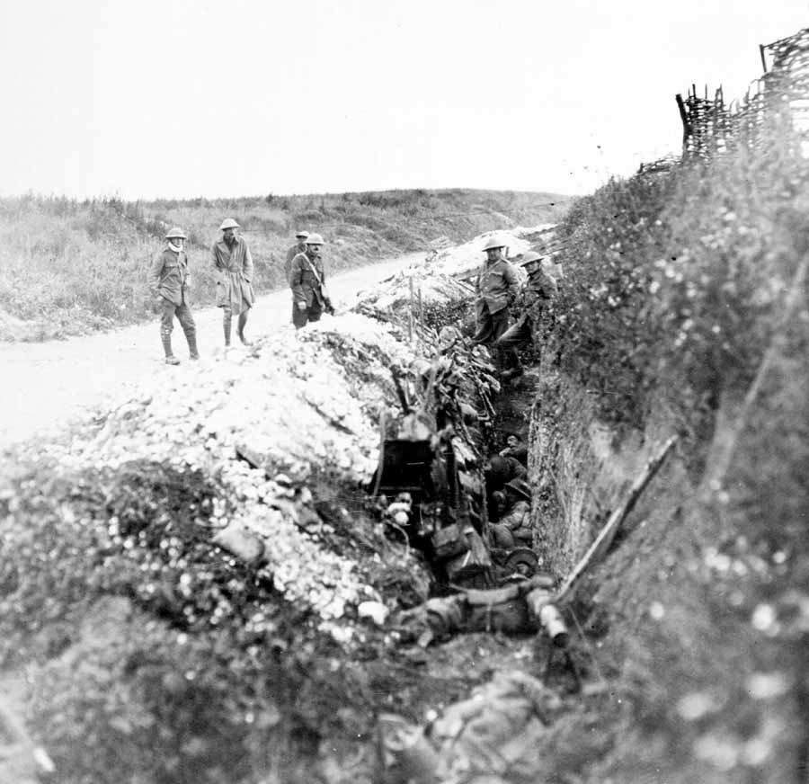 1916 Newfoundland soldiers along a road looking into a trench
