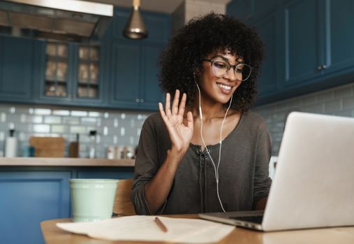 woman waving at a laptop