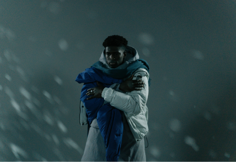 Man wearing jacket and shivering on a dark winter day