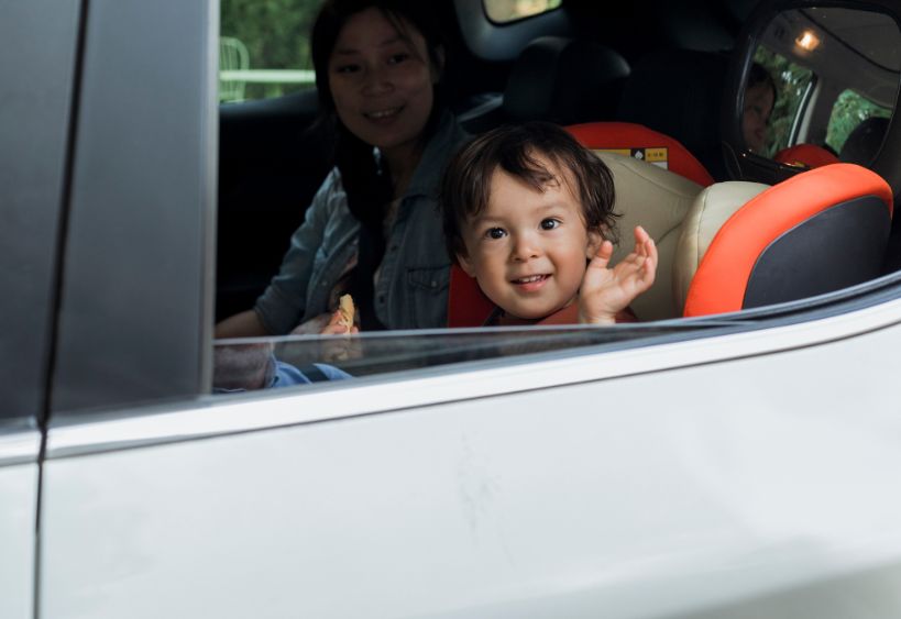 toddler waving from car