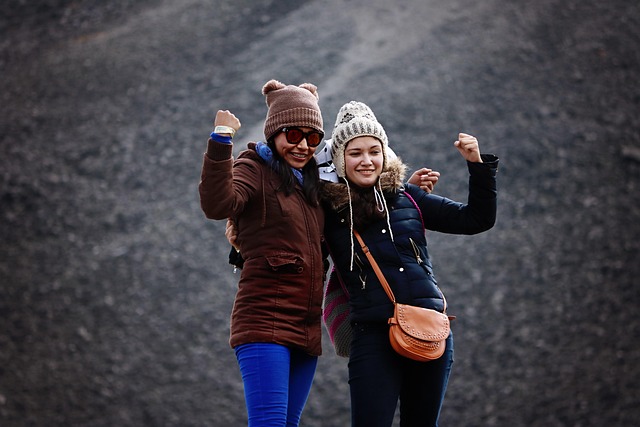 two girls posing with arms curled up