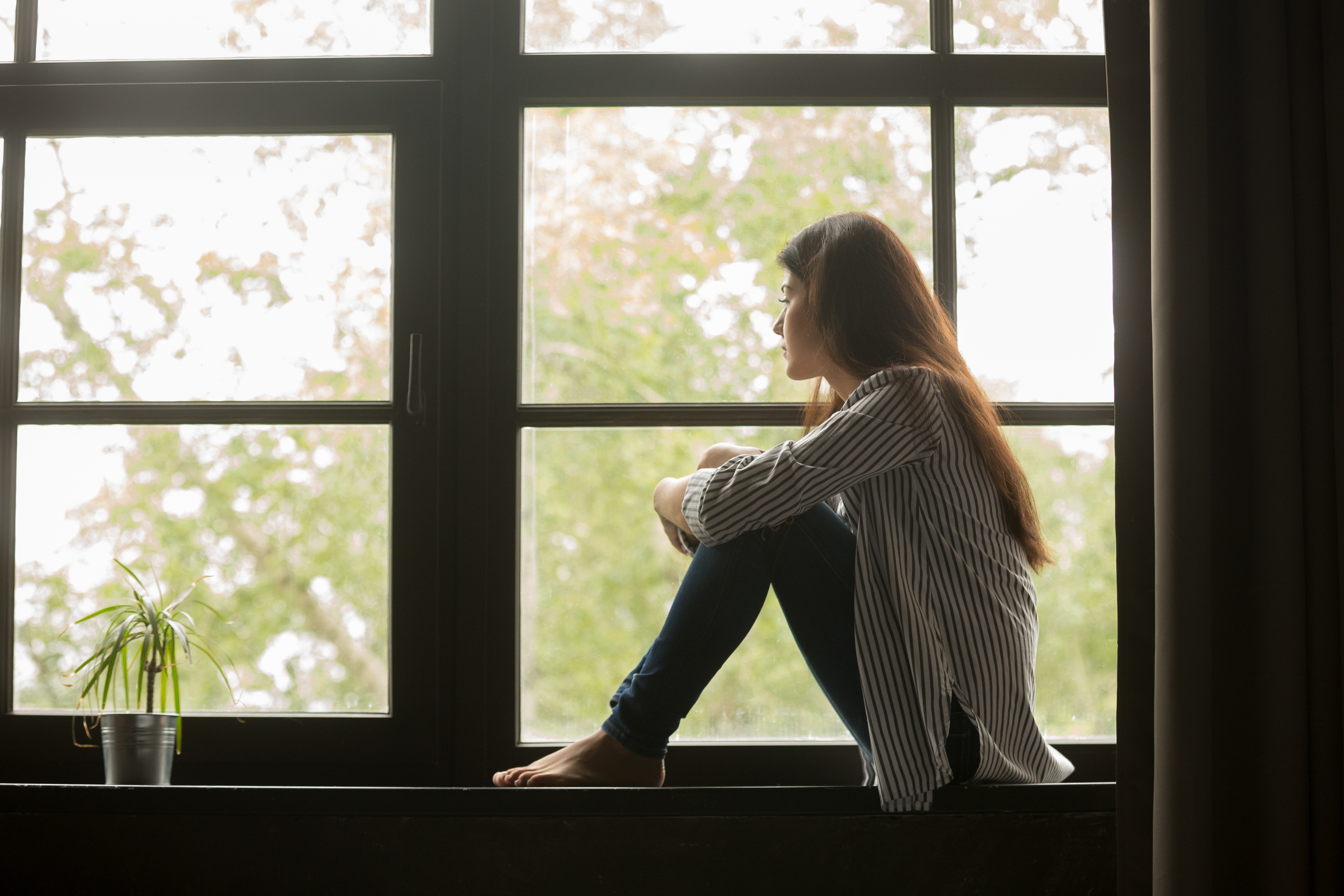 woman looking out a window