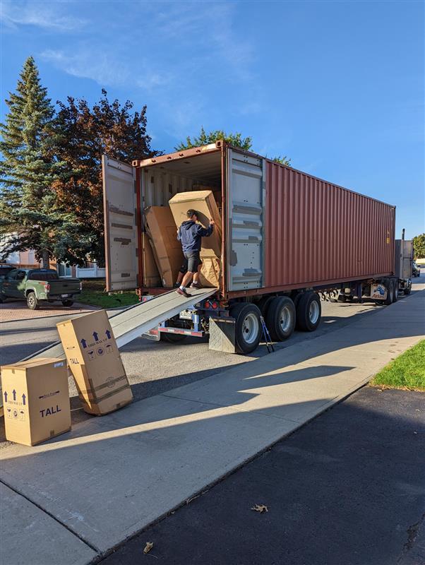 mover loading box into shipping container