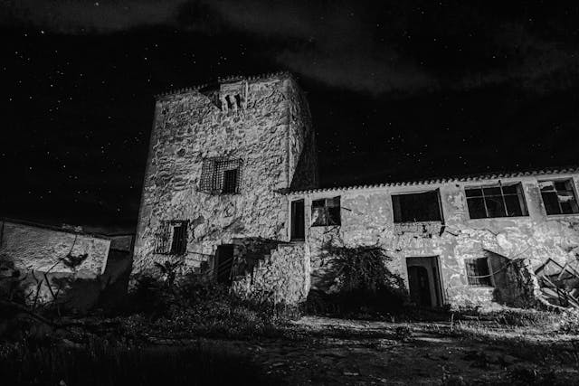 Black and White Abandoned Stone Building at Night
