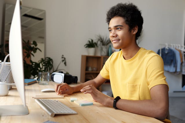 teenage boy sitting at a computer