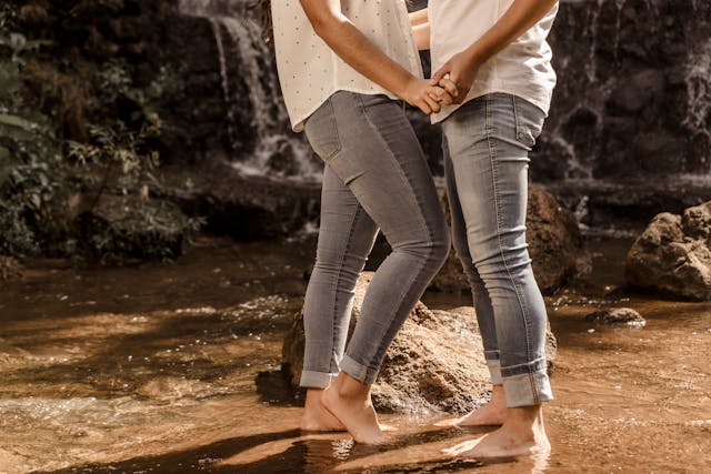 Couple Standing Barefoot in River