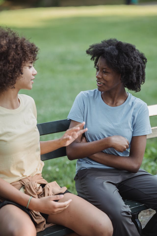 Mother and Child Sitting on Bench Talking