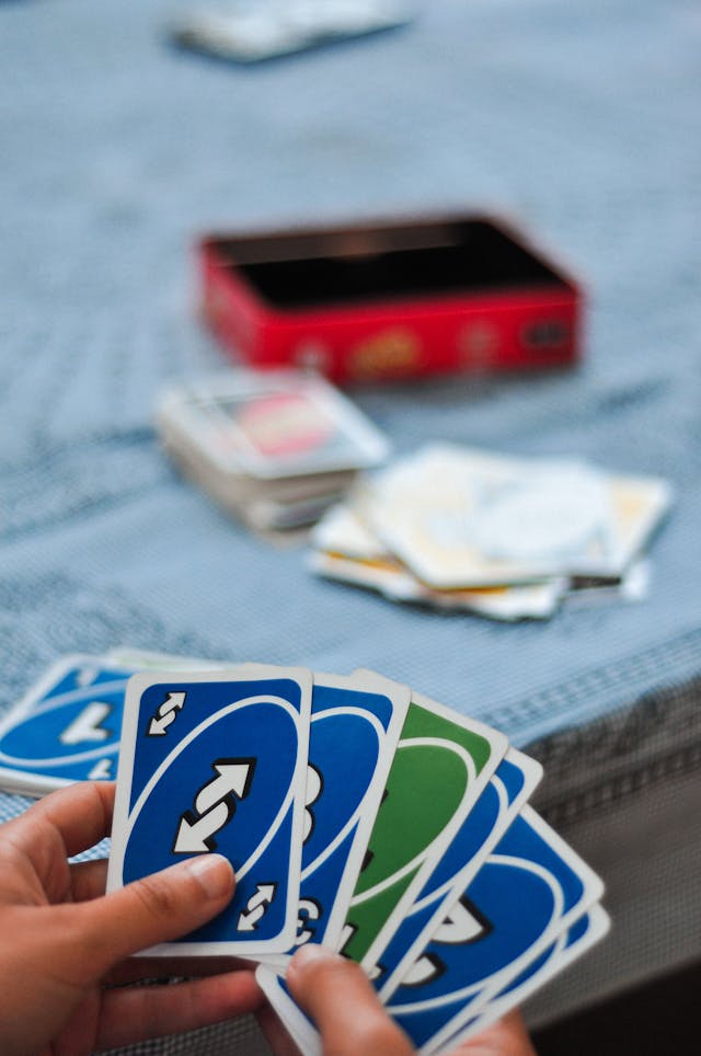 A Person Holding Uno Cards