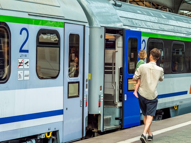 Man and child boarding a train at station