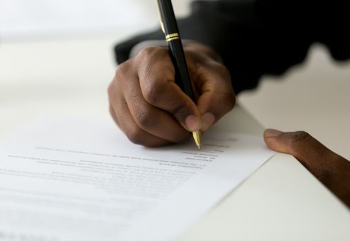 man writing with pen
