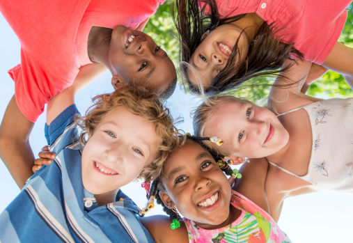 kids embracing each other and smiling 