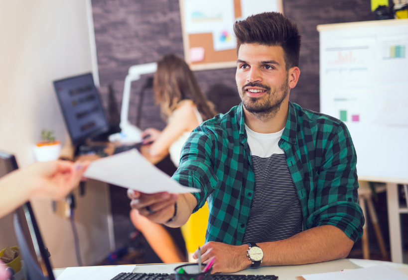 Man handing in a resume