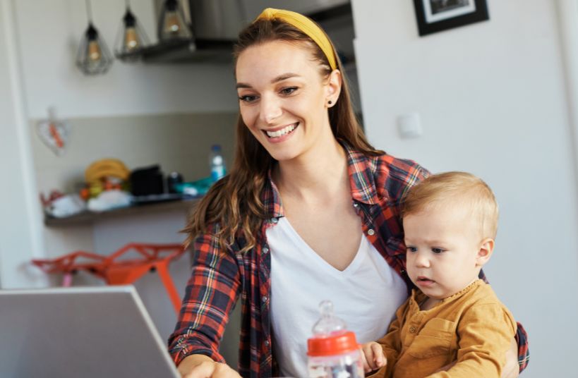 woman with child using computer