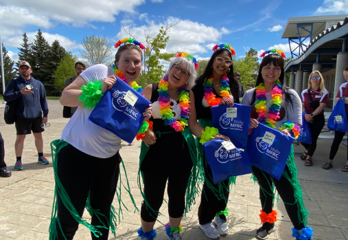 4 women in colourful Hawaiian costumes