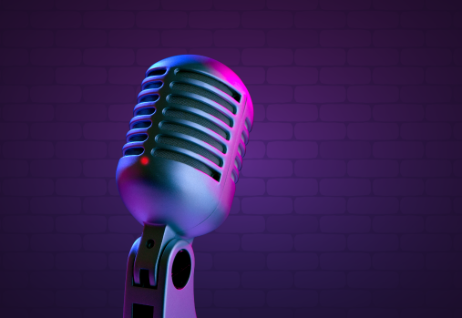 an old fashioned microphone in front of a purple brick wall