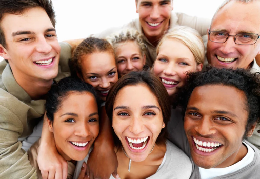 a group of adults smiling up at the camera