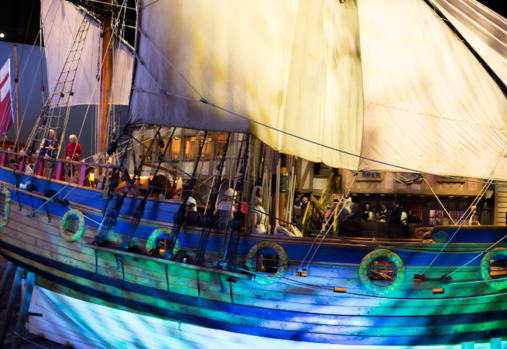 a photo of a 17th century ship with full sails out