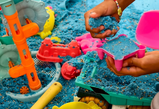 child playing in blue sand