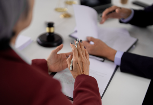 lawyer and client at a table looking at documents