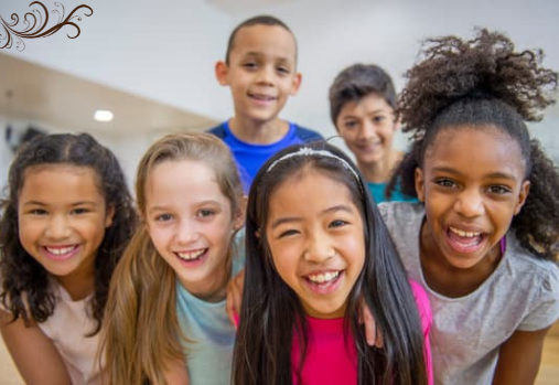 a group of school age children smiling at the camera