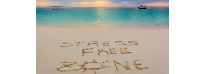 PICTURE OF A BEACH SCENE WITH THE WORDS 'STRESS FREE ZONE' WRITTEN IN SAND