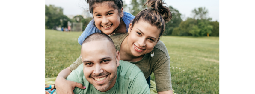 3 family members together in a park playing together